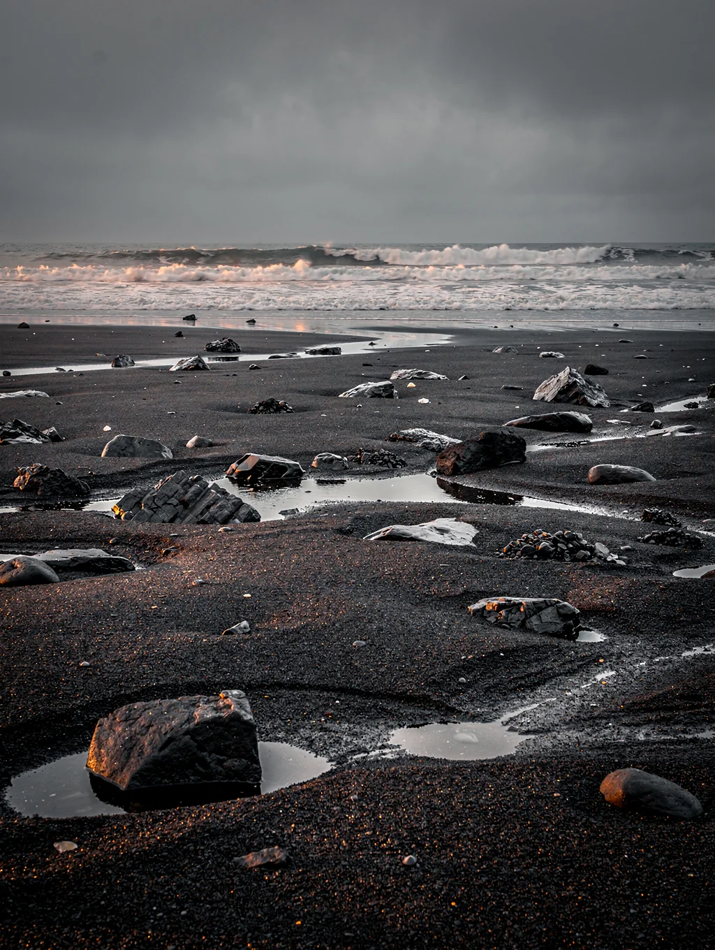 Abstract patterns in black volcanic sand on an Icelandic beach